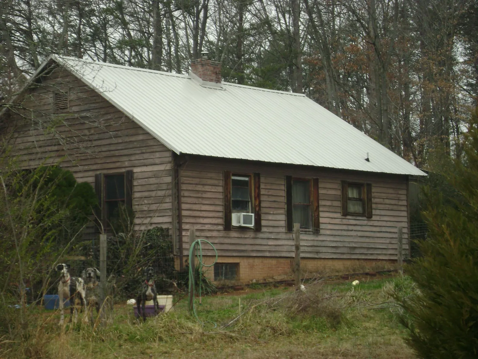 White metal roof on an old wood sided farmhouse, from a Metal Roof Installation job in Andrews Air Force Base